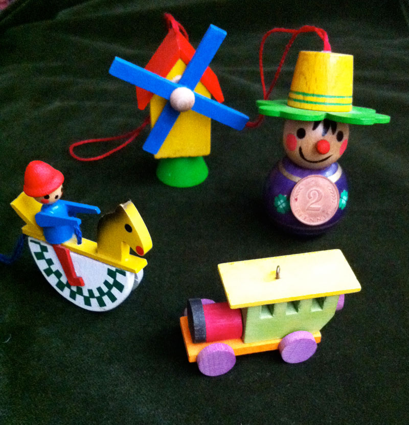 Soldier boy, windmill, figure with clover shaped hat holding 2 pfennig, front car of a train.