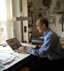 Paul at his desk pretending to use his computer.